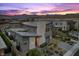Stunning exterior of a modern home with desert landscaping, mountain views, and stone accents at sunset at 12637 Penfield Ave, Las Vegas, NV 89138