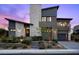 Modern home exterior showcases stone accents, a two-car garage, and manicured landscaping at 12637 Penfield Ave, Las Vegas, NV 89138