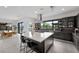 Modern kitchen featuring a large island with seating, sleek countertops, and stainless steel appliances at 12637 Penfield Ave, Las Vegas, NV 89138