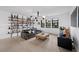 Bright and airy living room featuring hardwood floors, a leather couch, stylish lighting, and built in shelving at 12637 Penfield Ave, Las Vegas, NV 89138