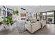 Stylish living room with fireplace, modern art, comfortable seating, and sliding doors to the outdoor area at 12637 Penfield Ave, Las Vegas, NV 89138