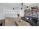 Spacious living room with hardwood floors, a cozy leather couch, stylish lighting, and built in shelving at 12637 Penfield Ave, Las Vegas, NV 89138