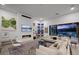 Cozy living room featuring a modern fireplace, stylish decor, and a seamless transition to the outdoor pool area at 12637 Penfield Ave, Las Vegas, NV 89138