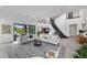 Spacious living room with modern decor, a large sectional sofa, and views of the backyard pool at 12637 Penfield Ave, Las Vegas, NV 89138