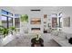 Modern living room with sleek fireplace, contemporary art, and large windows offering natural light at 12637 Penfield Ave, Las Vegas, NV 89138