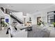 Bright, airy living room featuring modern decor, a grand staircase, and elegant furnishings at 12637 Penfield Ave, Las Vegas, NV 89138