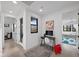 Bright home office with a modern desk setup, a view of the outdoors, and a glimpse of a playroom at 12637 Penfield Ave, Las Vegas, NV 89138