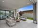 Elegant covered patio with modern outdoor seating and a view of the beautiful pool at 12637 Penfield Ave, Las Vegas, NV 89138