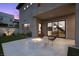 Charming backyard patio featuring a fire pit, sleek modern chairs, and an entrance to the main house at 12637 Penfield Ave, Las Vegas, NV 89138