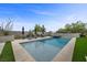 Luxurious pool area with spa, tanning deck, lounge chairs and desert landscaping at 12637 Penfield Ave, Las Vegas, NV 89138