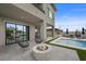 Well-appointed outdoor space with a fire pit, modern seating, and refreshing pool with lush landscaping at 12637 Penfield Ave, Las Vegas, NV 89138