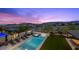 Beautiful pool and patio area with lounge chairs and mountain views at dusk at 12637 Penfield Ave, Las Vegas, NV 89138