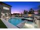 Beautiful backyard pool and spa with waterfall feature, lounge chairs, and outdoor living space at 12637 Penfield Ave, Las Vegas, NV 89138