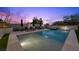 Relaxing pool with lounge chairs, spa, and manicured landscaping under a colorful sky at 12637 Penfield Ave, Las Vegas, NV 89138