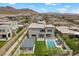 Stunning rear exterior featuring a pool, covered patio, and meticulously maintained landscaping against a mountain backdrop at 12637 Penfield Ave, Las Vegas, NV 89138