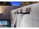Water feature spilling into the pool with modern wall and lighting at 12637 Penfield Ave, Las Vegas, NV 89138