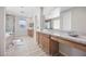 Bright bathroom features a large vanity with dual sinks, soaking tub, and glass enclosed shower at 13 Scenic Terrain Ave, Henderson, NV 89011