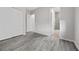 Bedroom featuring wood-look flooring, a walk-in closet, and an ensuite bathroom with a glass shower at 13 Scenic Terrain Ave, Henderson, NV 89011