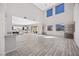 Spacious, open-concept living area with tile floors, large windows, and seamless transition to the kitchen at 13 Scenic Terrain Ave, Henderson, NV 89011
