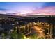 Street view at dusk showcasing a beautifully illuminated neighborhood with scenic mountain and city views at 13 Scenic Terrain Ave, Henderson, NV 89011