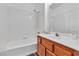 Bathroom showing white tiled tub with modern fixtures and a vanity with natural-toned cabinets at 1300 S Arlington St # 120, Las Vegas, NV 89104