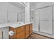Bathroom vanity with wood cabinets and hard surface counters, next to a shower with glass doors at 1300 S Arlington St # 120, Las Vegas, NV 89104