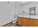 Bathroom featuring wood cabinets, a large mirror and modern fixtures at 1300 S Arlington St # 120, Las Vegas, NV 89104