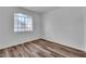 Bedroom with a large window providing natural light and wood-look flooring at 1300 S Arlington St # 120, Las Vegas, NV 89104