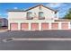 Exterior view of a garage with multiple pink garage doors and apartment units above at 1300 S Arlington St # 120, Las Vegas, NV 89104