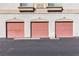 Row of pink garage doors, each labeled with unit numbers in a multi-unit dwelling at 1300 S Arlington St # 120, Las Vegas, NV 89104