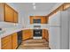 Functional kitchen featuring oak cabinets, white appliances and wood-look flooring at 1300 S Arlington St # 120, Las Vegas, NV 89104