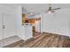 Bright living area showcasing hardwood floors, a ceiling fan and kitchen access at 1300 S Arlington St # 120, Las Vegas, NV 89104