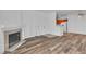 Open concept living space with fireplace, hardwood floors and view of kitchen at 1300 S Arlington St # 120, Las Vegas, NV 89104