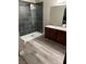 Modern bathroom featuring a spacious walk-in shower and granite countertop vanity at 1911 Bluegill Way # D, Henderson, NV 89014