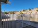 Spacious backyard is fenced with views of desert landscaping and distant hills at 2106 Pebble Creek Ln, Laughlin, NV 89029