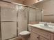 A bathroom featuring a white vanity and a shower with sliding glass doors at 2106 Pebble Creek Ln, Laughlin, NV 89029