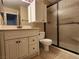 Bathroom featuring white vanity, granite counters, framed mirror and a shower with sliding doors at 2106 Pebble Creek Ln, Laughlin, NV 89029