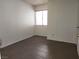 Bedroom featuring wood-look tile floors, a window, and white walls at 2106 Pebble Creek Ln, Laughlin, NV 89029