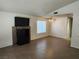 Inviting living room with wood-look tile flooring, ceiling fan, and natural light at 2106 Pebble Creek Ln, Laughlin, NV 89029