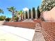 Enclosed backyard features desert landscaping, hardscape, block fence, and stairs at 2119 Sunset Vista Ave, Henderson, NV 89052