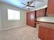 Bedroom featuring neutral carpet, a ceiling fan, and custom cabinets at 2119 Sunset Vista Ave, Henderson, NV 89052