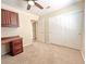 Bedroom with tan carpet, ceiling fan, and closet with sliding doors at 2119 Sunset Vista Ave, Henderson, NV 89052