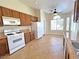 Bright kitchen with tile floors, white appliances, wood cabinets, and a cozy breakfast nook at 2119 Sunset Vista Ave, Henderson, NV 89052