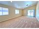 Bright living room featuring neutral carpet, a vaulted ceiling, and sliding glass doors at 2119 Sunset Vista Ave, Henderson, NV 89052