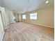 Open living room featuring neutral carpet, neutral paint, and access to other rooms at 2119 Sunset Vista Ave, Henderson, NV 89052
