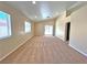 Spacious living room with neutral carpet and lots of natural light from two large windows at 2119 Sunset Vista Ave, Henderson, NV 89052