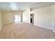 Spacious living room with neutral carpet and lots of natural light from sliding glass door at 2119 Sunset Vista Ave, Henderson, NV 89052