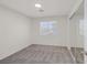Bright bedroom featuring plush gray carpet, large window and mirrored closet at 2367 Tilden Way, Henderson, NV 89074