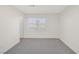 Bright bedroom featuring plush gray carpet and large window at 2367 Tilden Way, Henderson, NV 89074