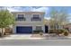 Charming two-story home featuring desert landscaping, a two-car garage, and decorative window awnings at 2367 Tilden Way, Henderson, NV 89074
